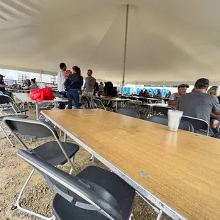 tables and chairs under a tent