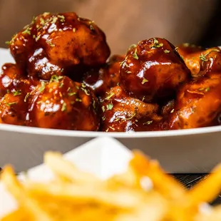 a plate of chicken wings and french fries