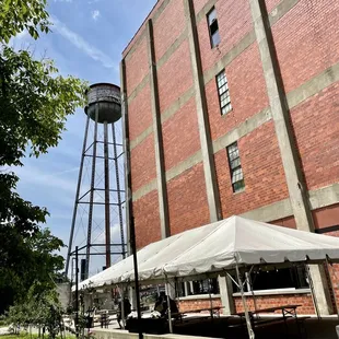 a brick building with a water tower in the background