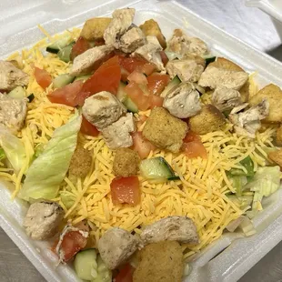 a salad in a styrofoam container
