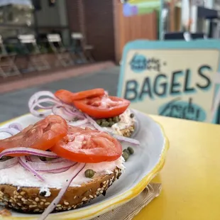 Everything bagel with salmon crema cheese. Onions, tomatoes, and capers