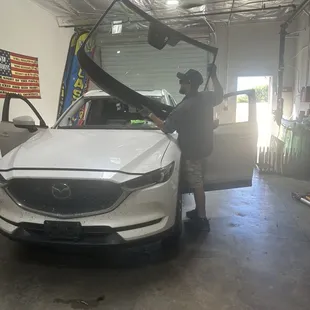 Luis taking off the old windshield