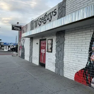 a brick building with graffiti on it