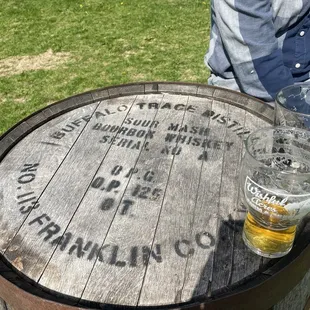 a beer glass on a barrel