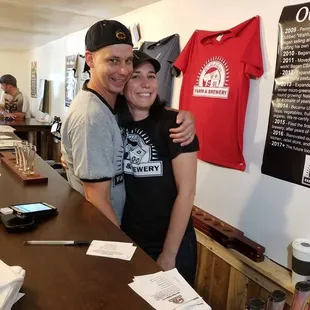 a man and woman standing in front of a counter