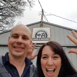 a man and a woman with their hands in the air