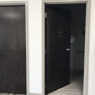 two black doors in a white room