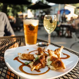 a plate of food and a glass of beer