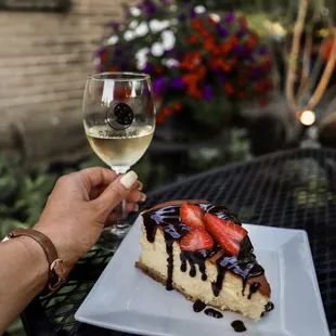 a piece of cake and a glass of wine