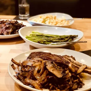 Dry-aged bone-in ribeye with caramelized onions and mushroom enhancements