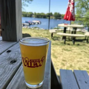a glass of beer on a picnic table