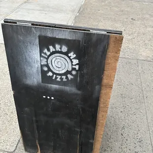 a sign on a sidewalk