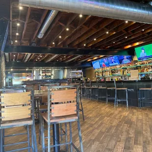a bar with wooden chairs