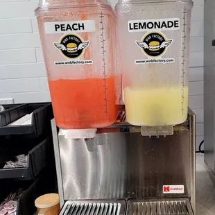 two juice dispensers on a counter
