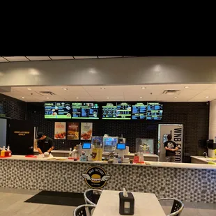 a restaurant counter with a lot of menus