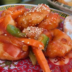 a colorful plate of food with a spoon