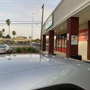 a car parked in front of a fast food restaurant