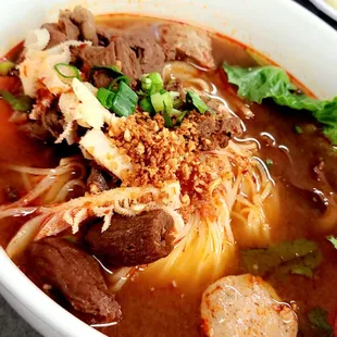 a bowl of soup with meat and vegetables