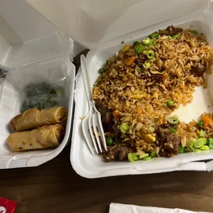 a take out container with rice and vegetables