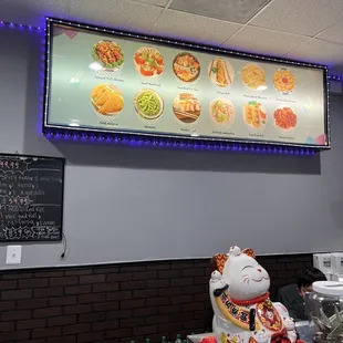 a restaurant with a menu on the wall