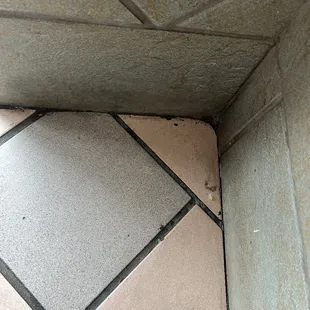 Corner of floor by the window seat.