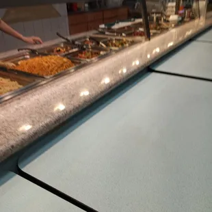 a man serving food at a buffet