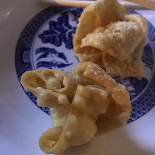 a plate of dumplings and chopsticks