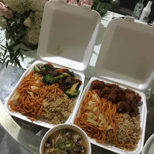 three takeout containers of food on a table