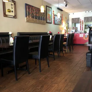 a dining area with black leather chairs