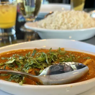 a bowl of curry with a spoon