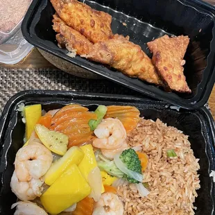 Shrimp stir fry with fried rice and chicken wontons in the back