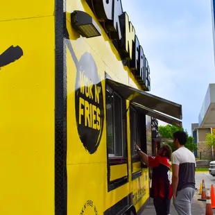 two people ordering food from a food truck