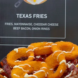a bowl of fries and bacon onion rings