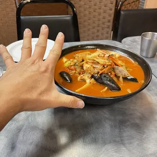 person holding a bowl of soup
