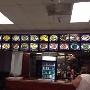 a woman standing at a counter in a restaurant