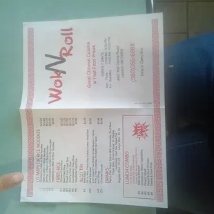 a person holding a menu