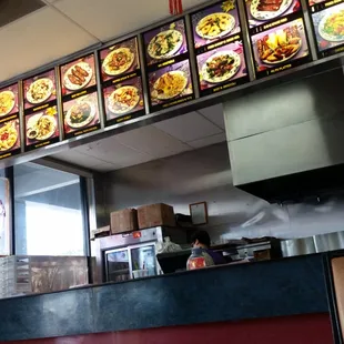 a man standing in front of a restaurant counter
