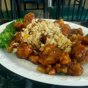 a plate of food with rice and broccoli