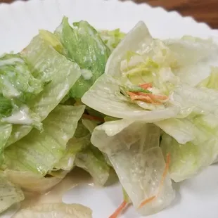 a salad on a paper plate