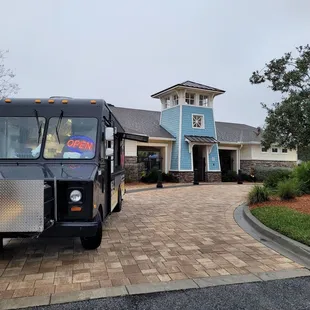 a food truck parked in front of a restaurant