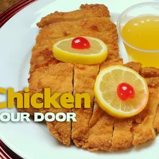 a plate of food with lemon chicken