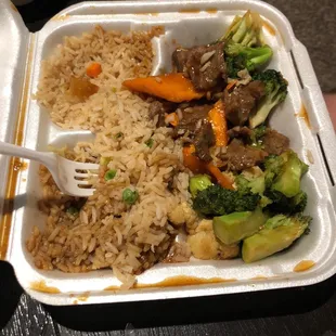 a tray of food with rice and vegetables