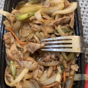 Lot of veg, but pink chicken at the top of the fork.