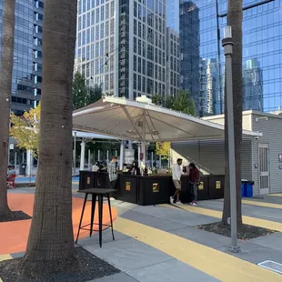 people sitting at a table under an umbrella