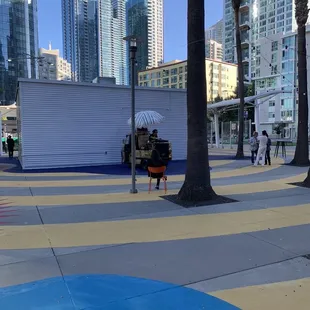 people walking on a sidewalk in a city