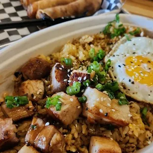 Pork belly plate with eggs and a side of brisket egg rolls.