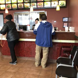 two people standing at a counter