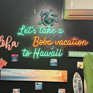 a neon sign that says let take a bola vacation to hawaii