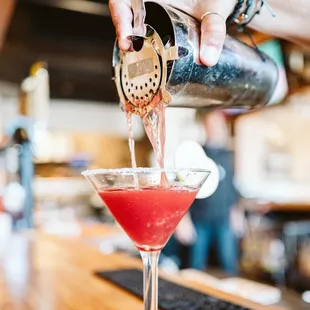 a bartender pouring a drink