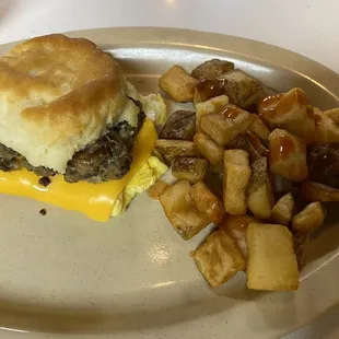 Breakfast biscuit with side of potatoes